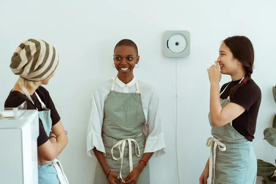 Three colleagues laughing and smiling at work making the most out of their internship stay